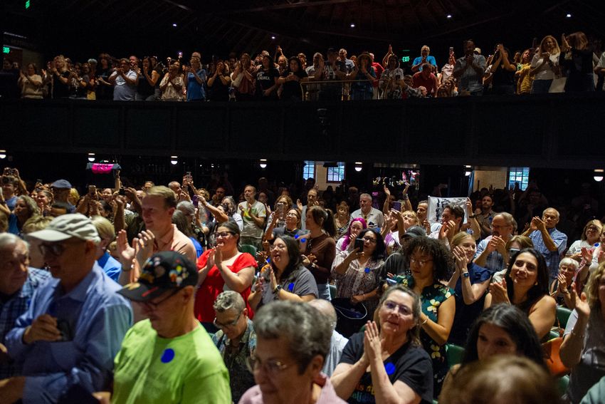 People cheer as Beto O'Rourke takes the stage to speak during a town hall at Stable Hall in San Antonio, Texas on June 27, 2025.